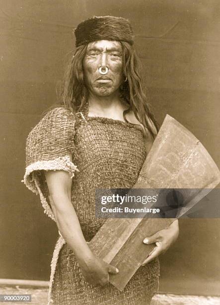 Hakalahl, Nakoaktok chief, three-quarter length portrait, standing, facing front, holding copper Wanistakila