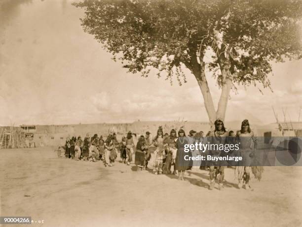 Tewa Indians dancing in line formation.