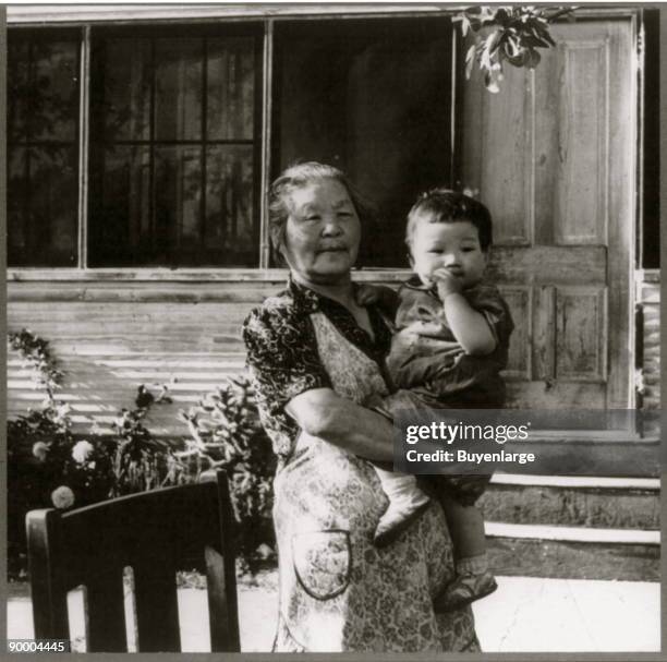 Mountain View, Calif., April 1942 - a grandmother and the youngest of 13 grandchildren photographed on a ranch in Santa Clara county before evacuees...