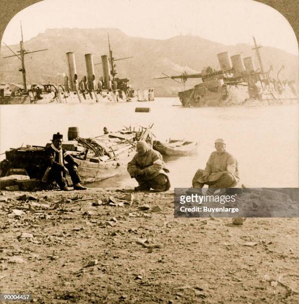 Russian ships 'Pallada' and 'Pobieda' wrecked below Golden Hill, Port Arthur; 3 Chinese sit on beach