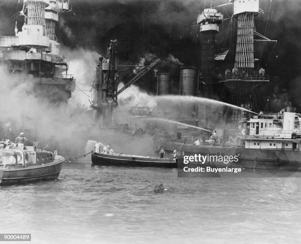 American battleship, the USS West Virginia on fire attack on Pearl Harbor by Japanese forces, 7th December 1941. Disregarding the dangerous...