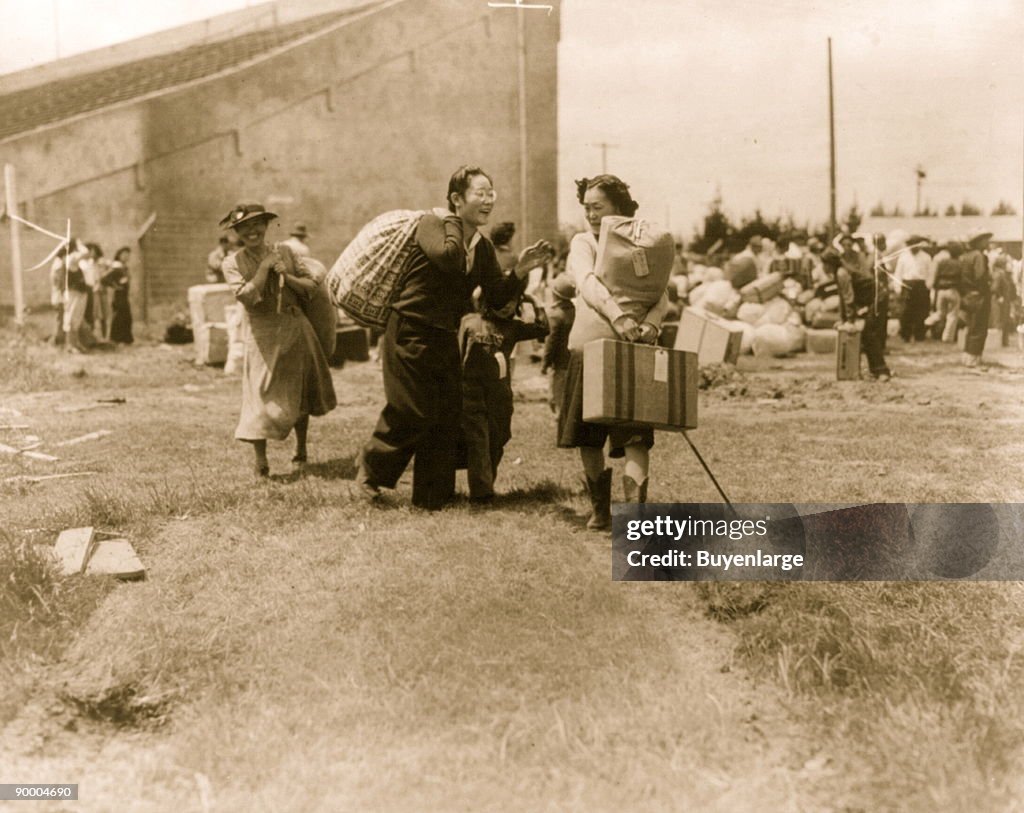Two Japanese evacuee families meeting at assembly center, Salinas rodeo grounds