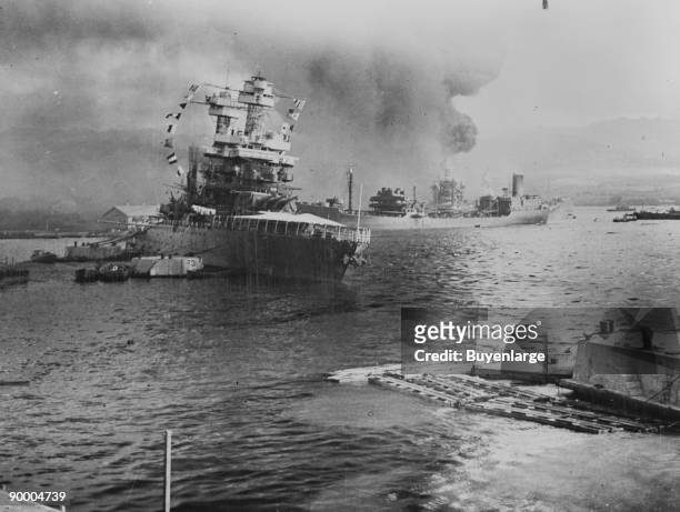 The U.S.S. Neosho, navy oil tanker, cautiously backs away from her berth in a successful effort to escape the Japanese attack on Pearl Harbor, Dec....