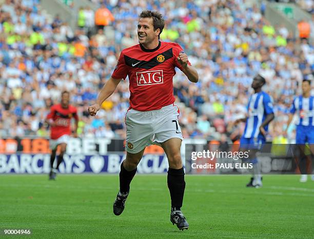 Manchester United's English forward Michael Owen celebrates scoring his first league goal for the club during the English Premier League football...