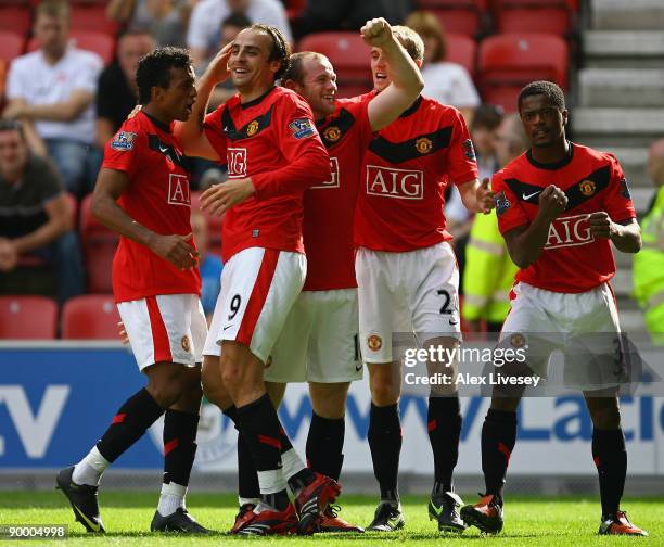 Dimitar Berbatov of Manchester United celebrates with his team mates after scoring the second goal during the Barclays Premier League match between...