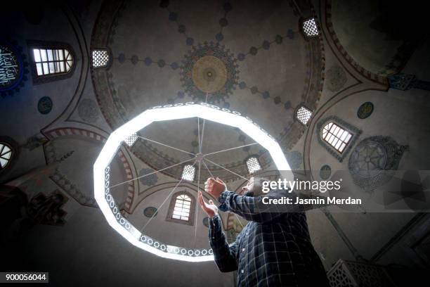 muslim man praying inside turkish mosque - muslim prayer stock pictures, royalty-free photos & images