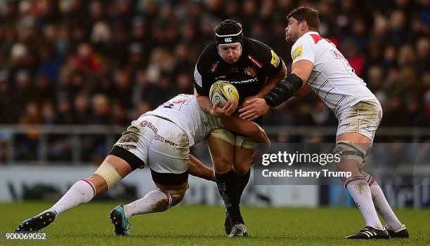 Thomas Waldrom of Exeter Chiefs is tackled by Michael Fitzgerald and Tafafu Polota-Nau of Leicester Tigers during the Aviva Premiership match between...