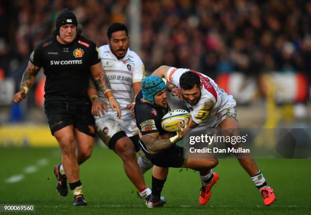 Jack Nowell of Exeter Chiefs is tackled by Adam Thompstone of Leicester Tigers during the Aviva Premiership match between Exeter Chiefs and Leicester...