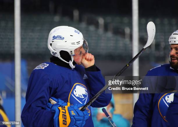 Jack Eichel of the Buffalo Sabres tries to stay warm during practice at Citi Field on December 31, 2017 in the Flushing neighborhood of the Queens...