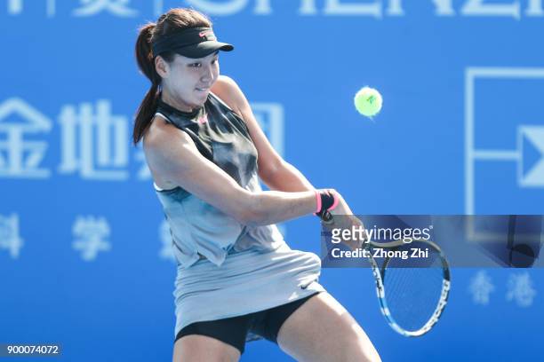 Xinyu Wang of China returns a shot during the match against Danka Kovinic of Montenegro during Day 1 of 2018 WTA Shenzhen Open at Longgang...