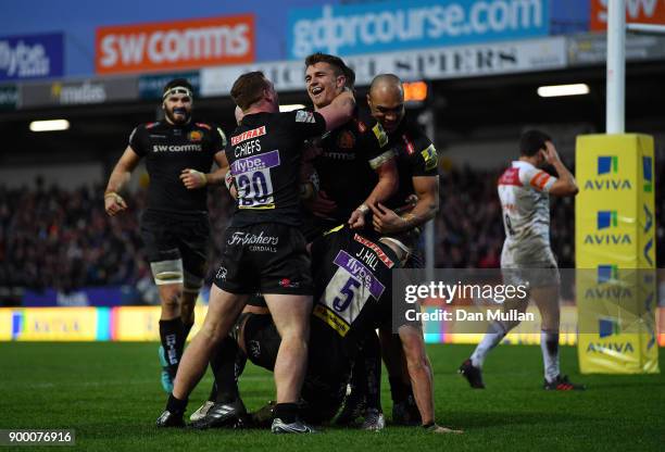 Henry Slade of Exeter Chiefs celebrates with his team mates after scoring his side's second try during the Aviva Premiership match between Exeter...