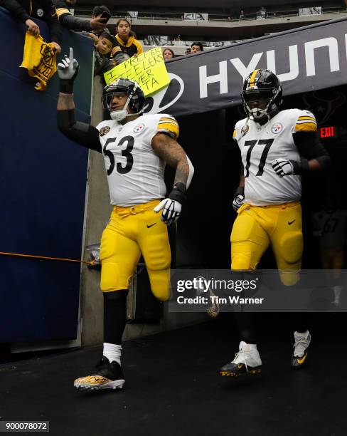 Maurkice Pouncey of the Pittsburgh Steelers and Marcus Gilbert run out of the tunnel before the game against the Houston Texans at NRG Stadium on...