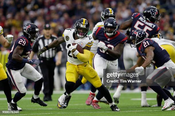 Le'Veon Bell of the Pittsburgh Steelers avoids a tackle by Marcus Gilchrist of the Houston Texans in the first half at NRG Stadium on December 25,...