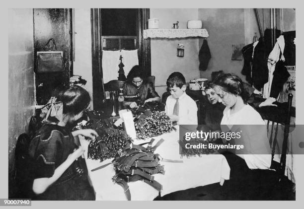 Family Sitting at Table Working with Garters