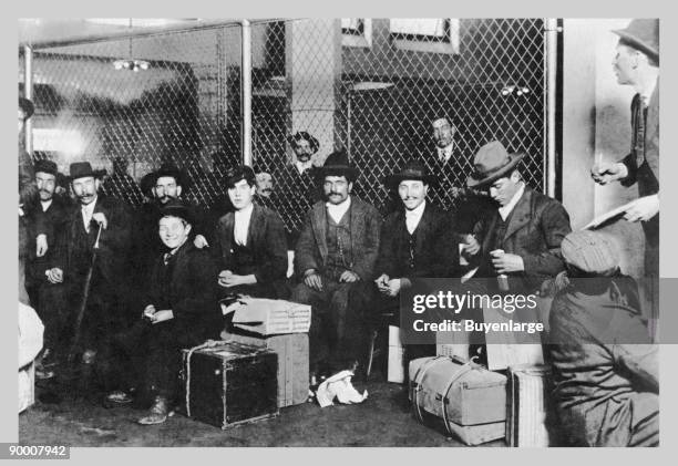 Immigrant Men Sitting at Ellis Island