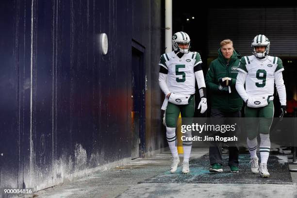 Christian Hackenberg, Josh McCown, and Bryce Petty of the New York Jets walk onto the field before the game against the New England Patriots at...