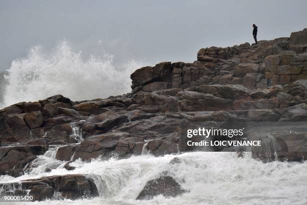 Man looks at heavy waves, on December 31, 2017 in Batz-sur-Mer, western France, a day before storm Carmen is to hit the west of France.