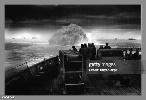 The crew of US Coast Guard cutter Spencer watch one of their depth charges explode as they defend a convoy during a U-boat attack in the North...