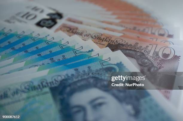 The new polymer British ten and five pounds banknotes are pictured in London, on December 31, 2017. Currency experts have warned that as the...