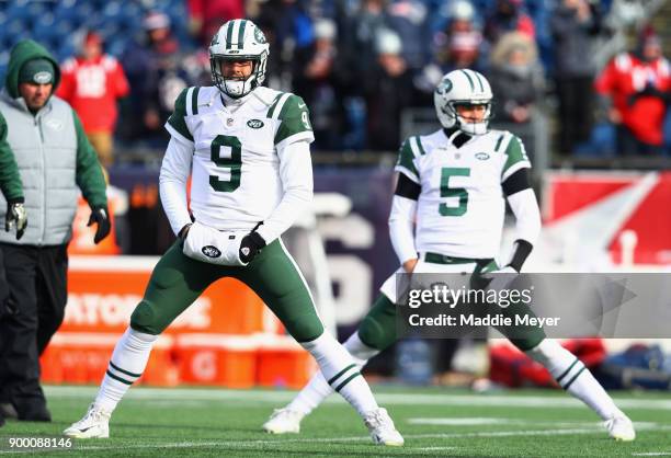 Bryce Petty and Christian Hackenberg of the New York Jets stretch before the game against the New England Patriots at Gillette Stadium on December...