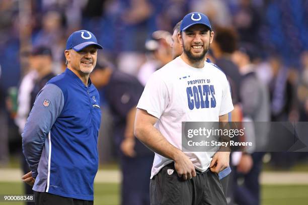 Head coach Chuck Pagano of the Indianapolis Colts talks with Andrew Luck prior to the game against the Houston Texans at Lucas Oil Stadium on...