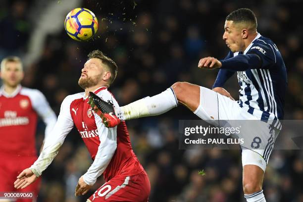 West Bromwich Albion's English midfielder Jake Livermore vies with Arsenal's German defender Shkodran Mustafi during the English Premier League...