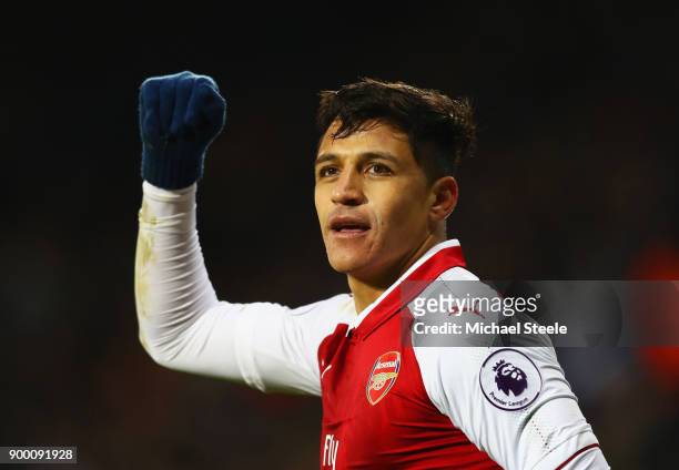 Alexis Sanchez of Arsenal celebrates as his free kick deflects off James McClean of West Bromwich Albion for their first goal during the Premier...