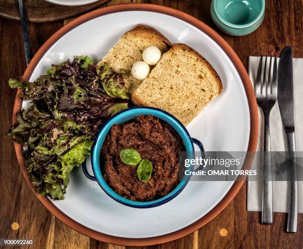 Beef stew cooked with fruits and vegetables served with slices of bread, pearls of butter, cheese and salad at the Zandunga restaurant which offers...