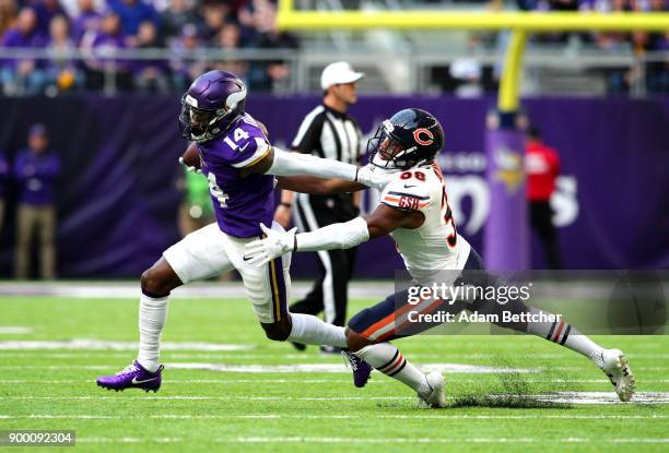 Stefon Diggs of the Minnesota Vikings carries the ball and stiff arms Adrian Amos of the Chicago Bears in the first quarter of the game on December...