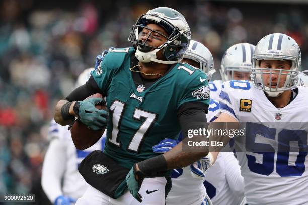 Cornerback Chidobe Awuzie and middle linebacker Sean Lee of the Dallas Cowboys tackle wide receiver Alshon Jeffery of the Philadelphia Eagles during...