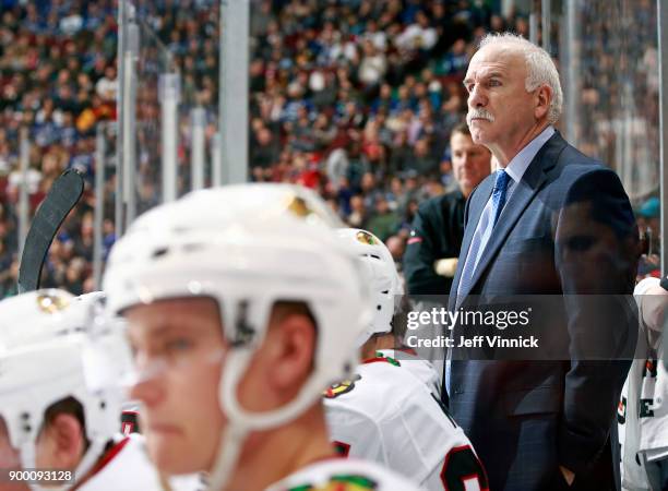 Joel Quenneville of the Chicago Blackhawks looks on from the bench during their NHL game against the Vancouver Canucks at Rogers Arena December 28,...