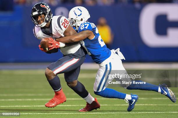 Nate Hairston of the Indianapolis Colts tackles Alfred Blue of the Houston Texans during the first half at Lucas Oil Stadium on December 31, 2017 in...