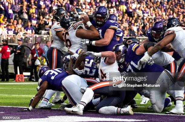Latavius Murray of the Minnesota Vikings dives into the end zone with the ball to score a touchdown in the second quarter of the game against the...