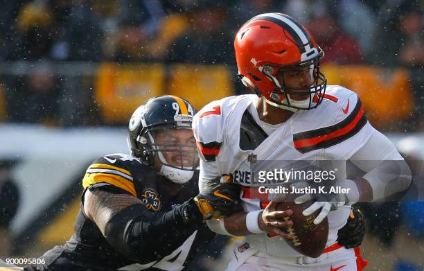 DeShone Kizer of the Cleveland Browns is sacked by Tyson Alualu of the Pittsburgh Steelers in the first quarter during the game at Heinz Field on...