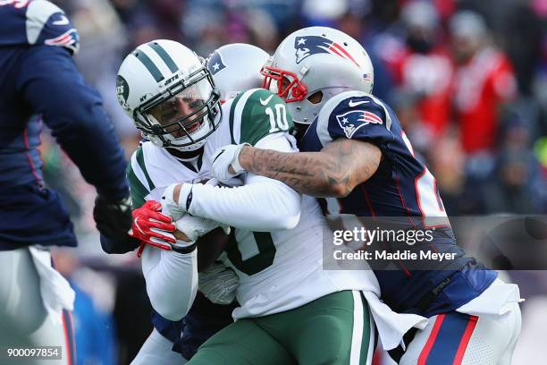 Jermaine Kearse of the New York Jets is tackled by Patrick Chung of the New England Patriots during the first half at Gillette Stadium on December...