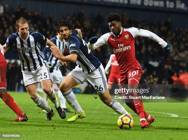 Ainsley Maitland-Niles of Arsenal takes on Ahmed Hegazi and Craig Dawson of WBA during the Premier League match between West Bromwich Albion and...