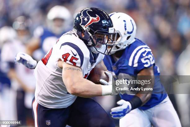 Jay Prosch of the Houston Texans runs with the ball defended by Barkevious Mingo of the Indianapolis Colts during the first half at Lucas Oil Stadium...