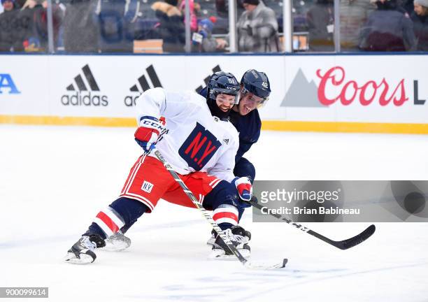 David Desharnais and Brendan Smith of the New York Rangers skate during practice at Citi Field on December 31, 2017 in the Flushing neighborhood of...