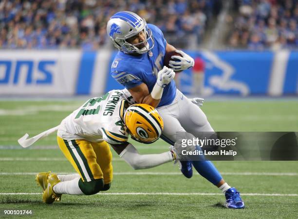 Golden Tate of the Detroit Lions runs for yardage against Lenzy Pipkins of the Green Bay Packers during the first half at Ford Field on December 31,...