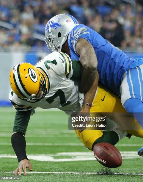 Quarterback Brett Hundley of the Green Bay Packers fumbles the ball as he is hit by Glover Quin of the Detroit Lions during the first half at Ford...