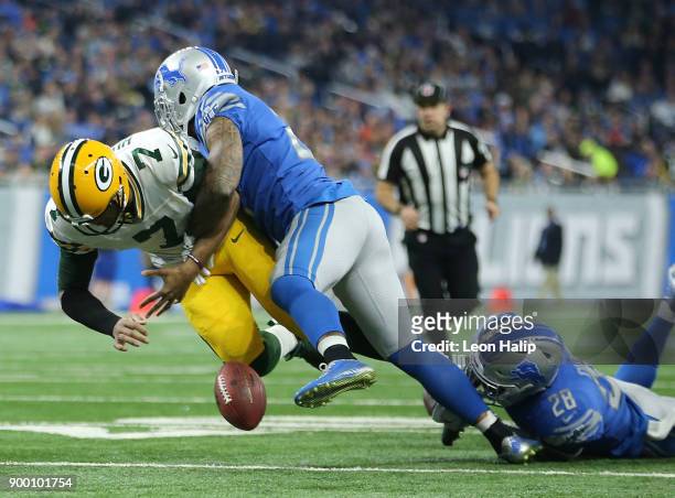 Quarterback Brett Hundley of the Green Bay Packers fumbles the ball as he is hit by Glover Quin of the Detroit Lions and Quandre Diggs during the...