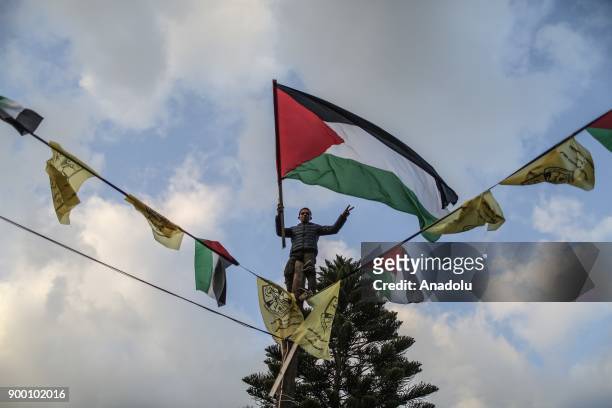 Palestinians gather to mark the 53th Foundation anniversary of Palestinian Fatah movement at Unknown Soldiers Monument in Gaza City, Gaza on December...