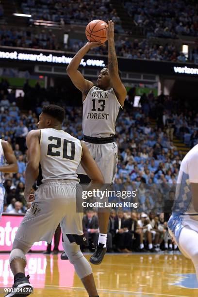 Bryant Crawford of the Wake Forest Demon Deacons puts up a shot against the North Carolina Tar Heels at Dean Smith Center on December 30, 2017 in...
