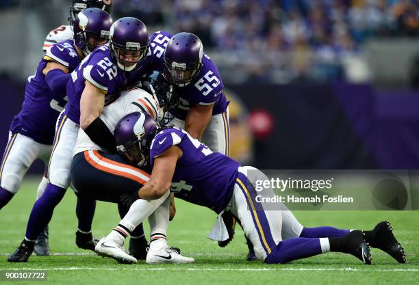 Kendall Wright of the Chicago Bears is tackled with the ball by a group of Minnesota Vikings players in the third quarter of the game on December 31,...