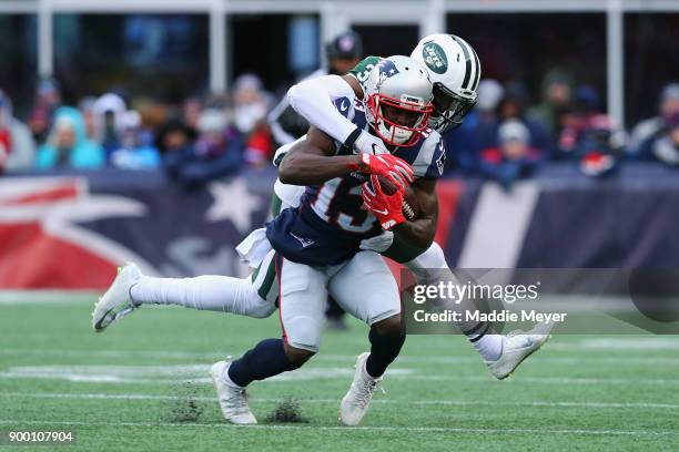 Juston Burris of the New York Jets tackles Phillip Dorsett of the New England Patriots during the second half at Gillette Stadium on December 31,...