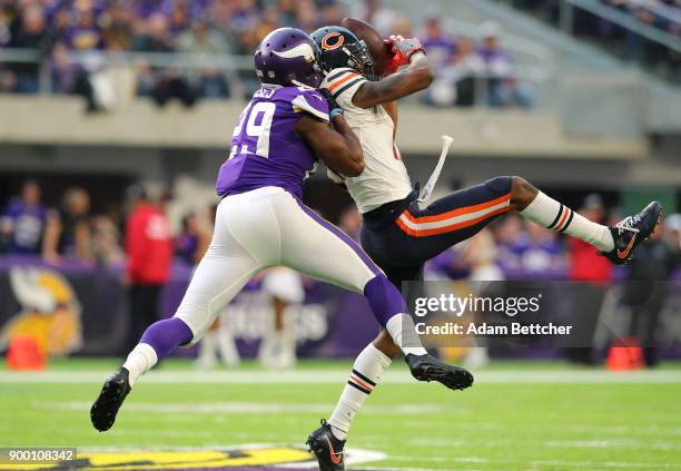 Dontrelle Inman of the Chicago Bears catches the ball while being hit by Xavier Rhodes of the Minnesota Vikings in the fourth quarter of the game on...