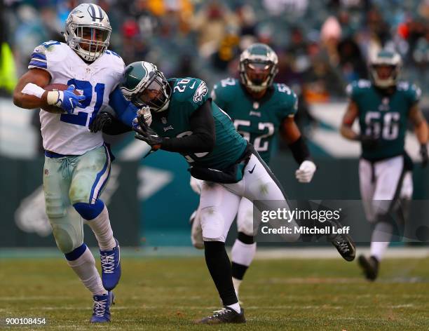 Running back Ezekiel Elliott of the Dallas Cowboys runs for a first-down as he pushed out of bounds by cornerback Jaylen Watkins of the Philadelphia...