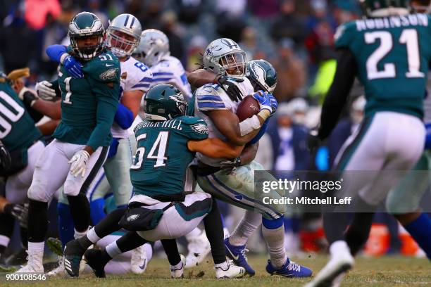 Running back Ezekiel Elliott of the Dallas Cowboys runs for a first down against linebacker Dannell Ellerbe and outside linebacker Kamu Grugier-Hill...