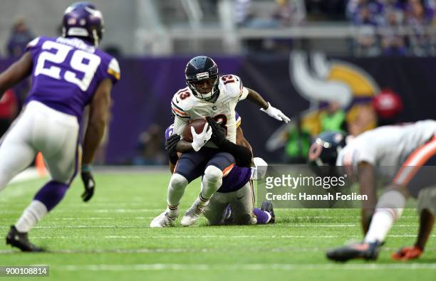 Kendall Wright of the Chicago Bears is tackled with the ball by Danielle Hunter of the Minnesota Vikings in the fourth quarter of the game on...