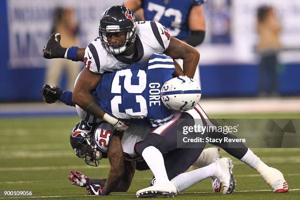 Zach Cunningham and Kareem Jackson of the Houston Texans tackle Frank Gore of the Indianapolis Colts during the second half at Lucas Oil Stadium on...